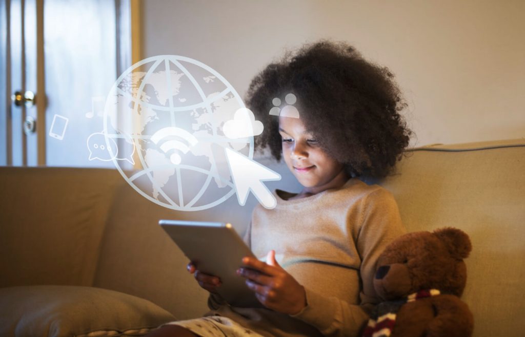 criança usando um tablet e navegando na internet após a contratação de um provedor de internet